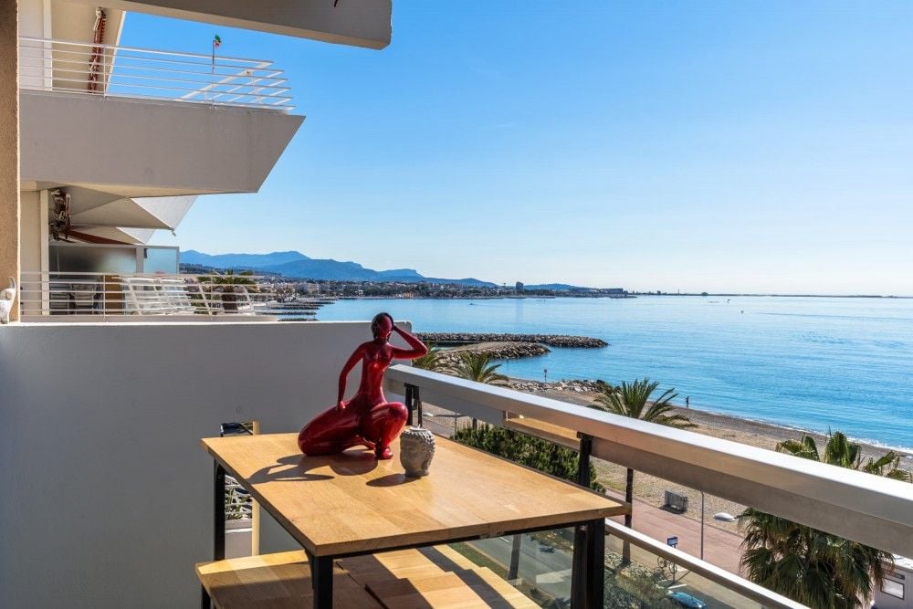 Balcony with table and a view along the coast at Cagnes-sur-Mer, 2-bedroom apartment in Cagnes-sur-Mer