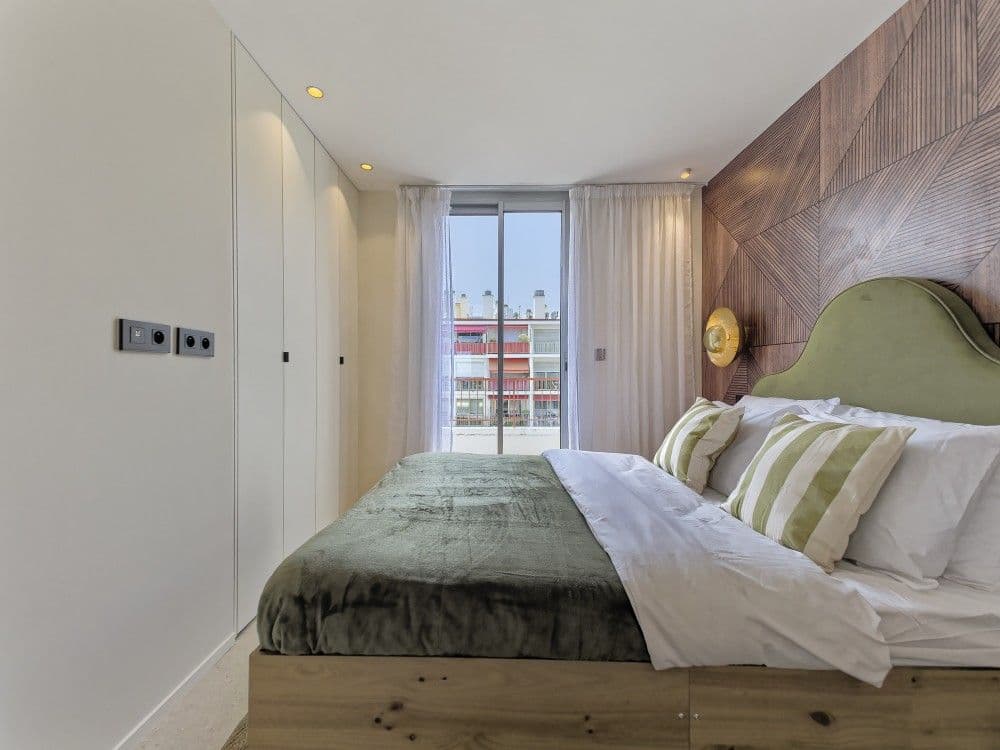 Bedroom with green headboard and fitted wardrobe, 2-bedroom apartment in the Promenade des Anglais, Nice