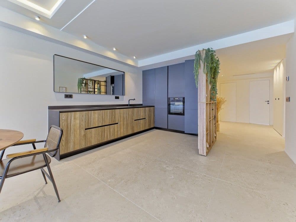 Kitchen with wood-fronted units and blue tall cabinets, 2-bedroom apartment in the Promenade des Anglais, Nice