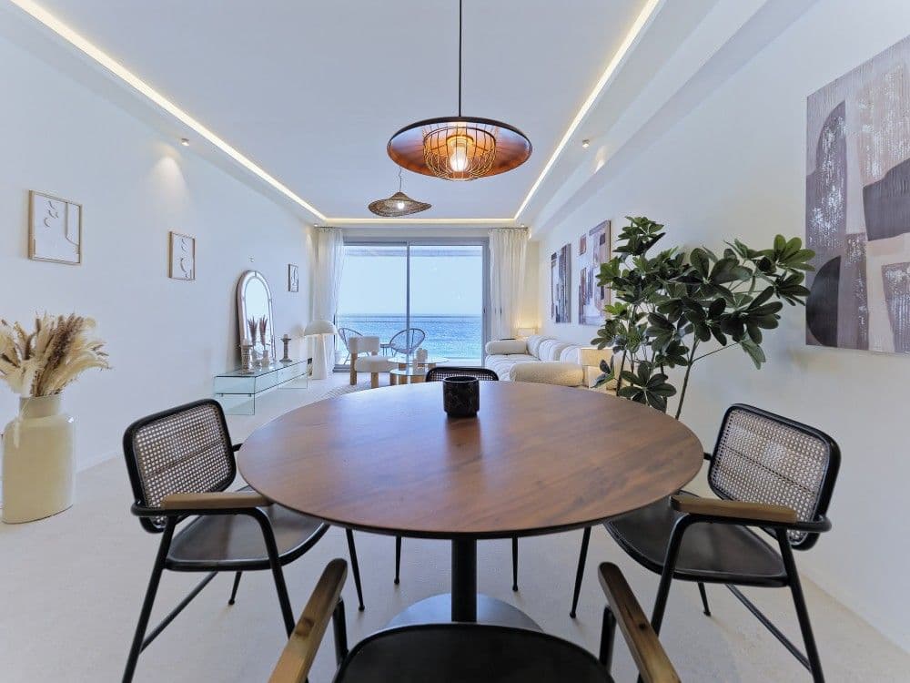 Dining area with sea view at the end of the room, 2-bedroom apartment in the Promenade des Anglais, Nice
