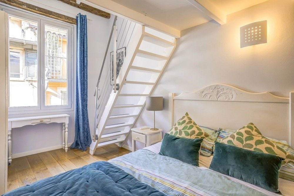 Bedroom with stairs to the mezzanine, 2-bedroom apartment in the Old Town, Nice