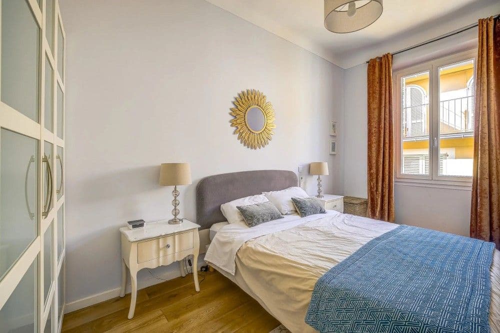 Bedroom with grey headboard and window, 2-bedroom apartment in the Old Town, Nice