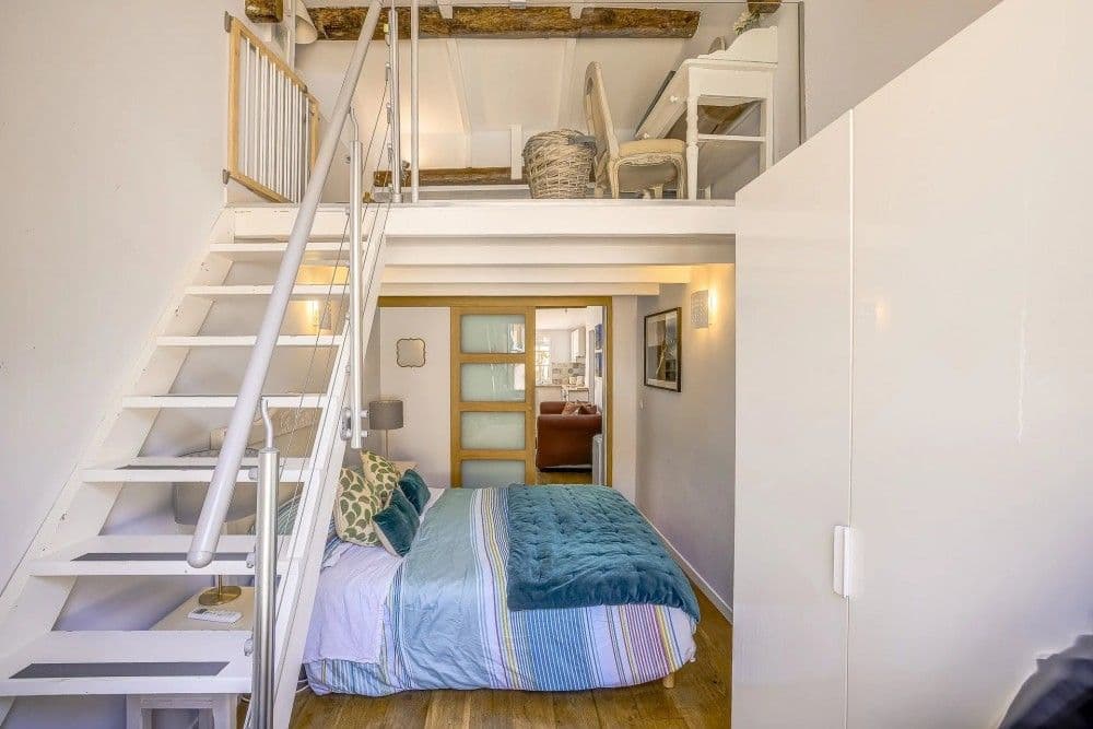 Mezzanine above the bedroom with white staircase, 2-bedroom apartment in the Old Town, Nice