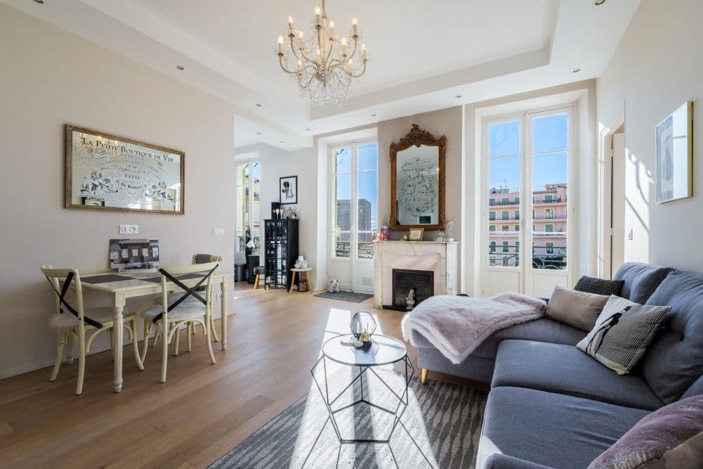 Living room with dining table and marble fireplace, 2-bedroom apartment in central Nice