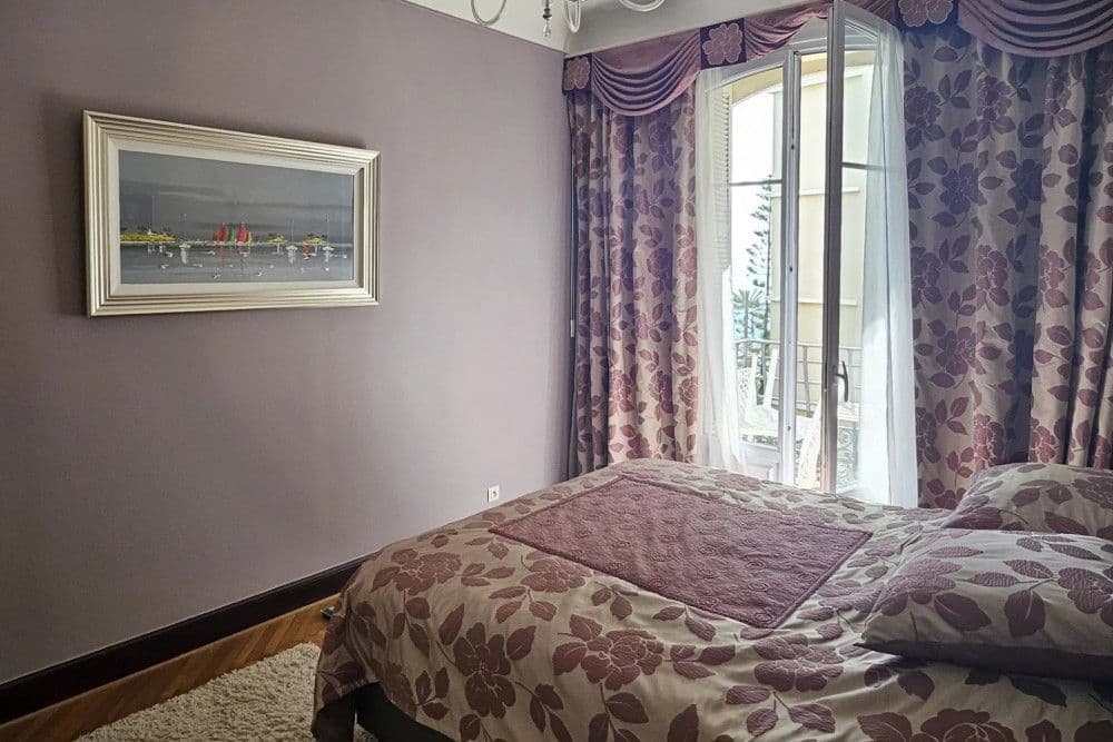 Bedroom with French window and floral curtains, 3-bedroom apartment in the Promenade des Anglais, Nice