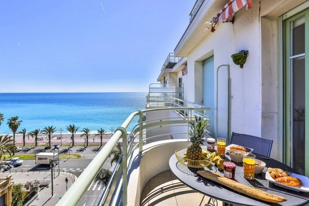 Balcony with breakfast table overlooking the Promenade des Anglais and the sea, 2-bedroom apartment in the Promenade des Anglais, Nice