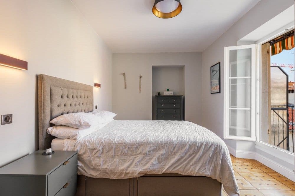 Bedroom with upholstered headboard and French window, 2-bedroom apartment in central Nice