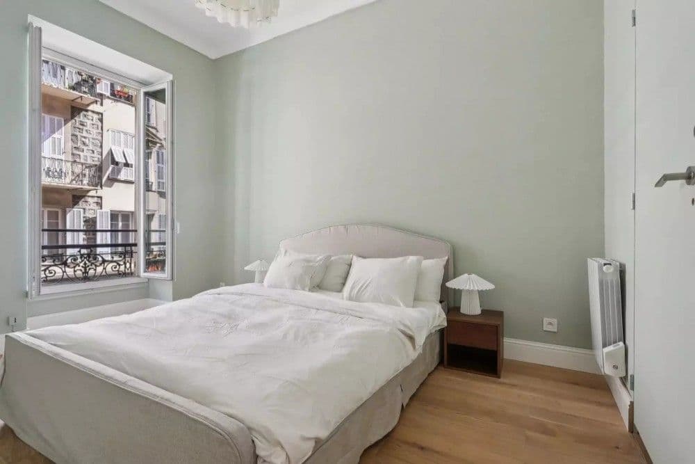 Bedroom with sage green walls and window, 2-bedroom apartment in central Nice