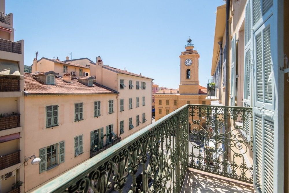 Balcony with wrought-iron railing overlooking the Old Town and its clock tower, 2-bedroom apartment in the Port, Nice