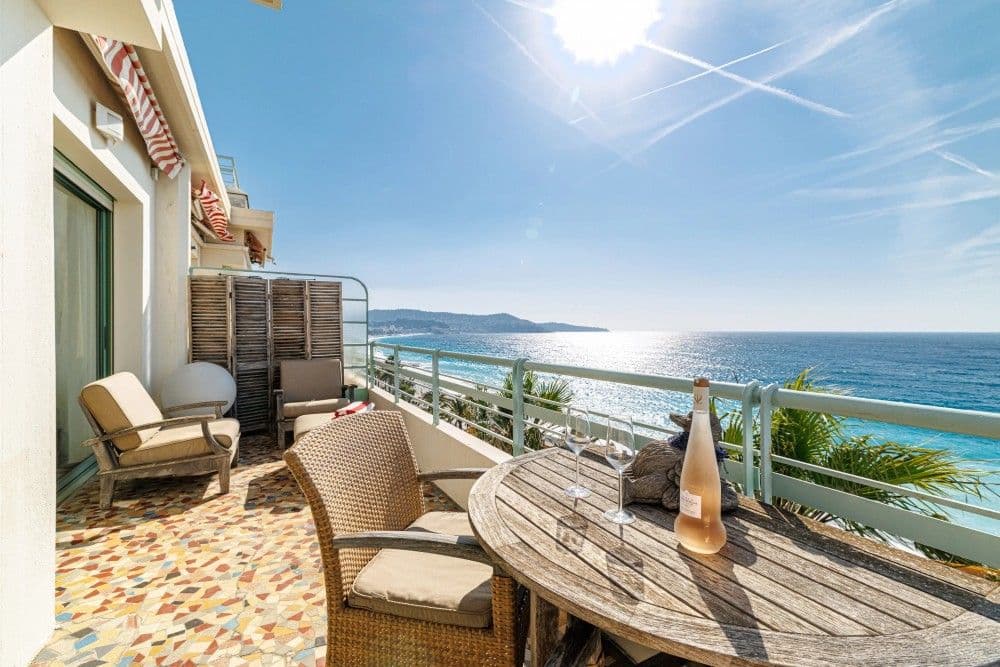 Terrace with wicker chairs and a view along the coast, 3-bedroom apartment in the Promenade des Anglais, Nice
