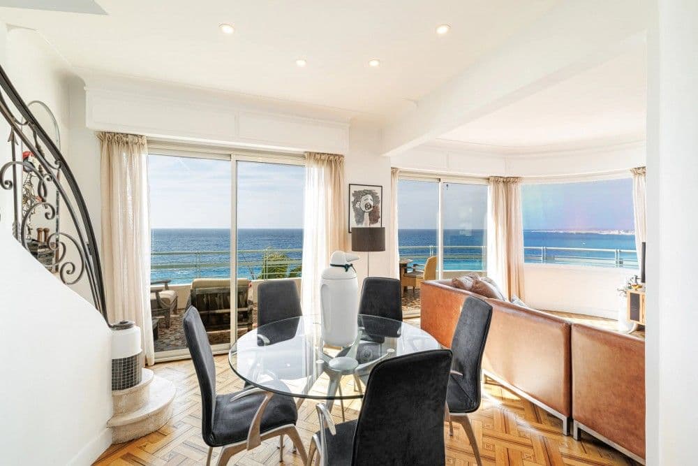 Dining area with glass table and wrought-iron staircase, 3-bedroom apartment in the Promenade des Anglais, Nice
