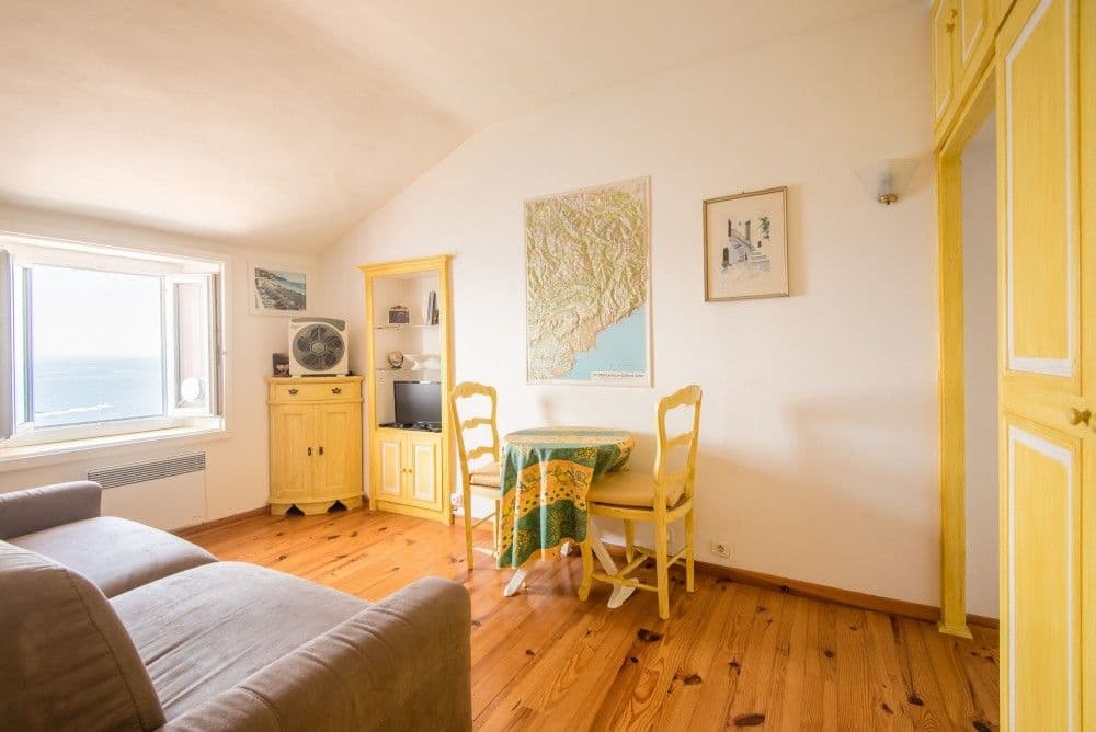 Sitting area with sofa, table and sea-view window, 3-bedroom apartment in the Promenade des Anglais, Nice