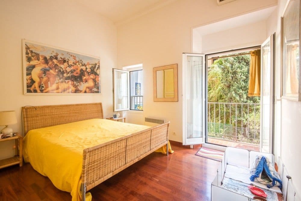Bedroom with wicker bed and French window, 3-bedroom apartment in the Promenade des Anglais, Nice