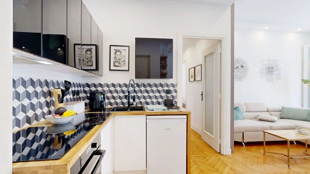 Kitchen with geometric tiled splashback and wooden worktop, 1-bedroom apartment in the Promenade des Anglais, Nice