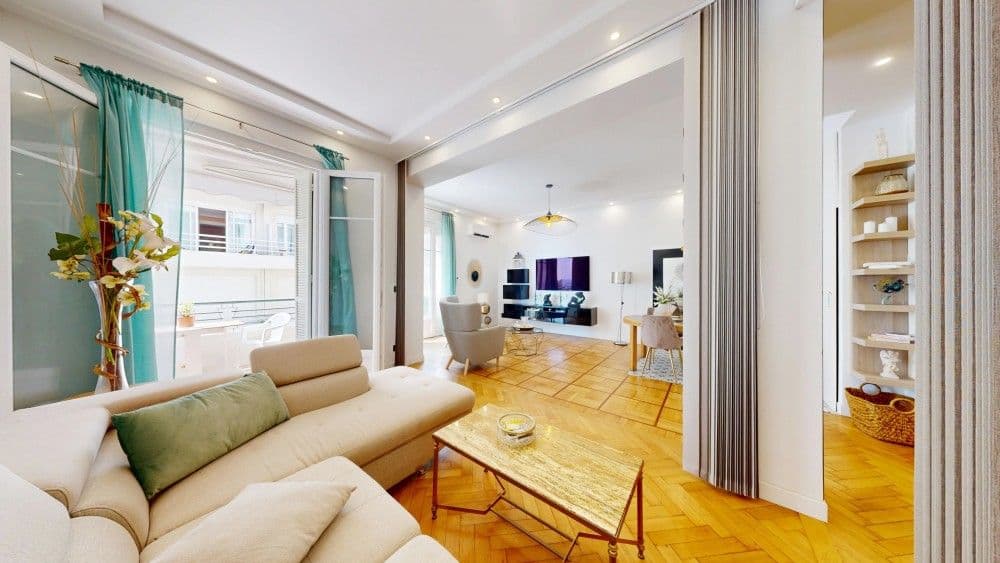 Living room with corner sofa and parquet floor, 1-bedroom apartment in the Promenade des Anglais, Nice
