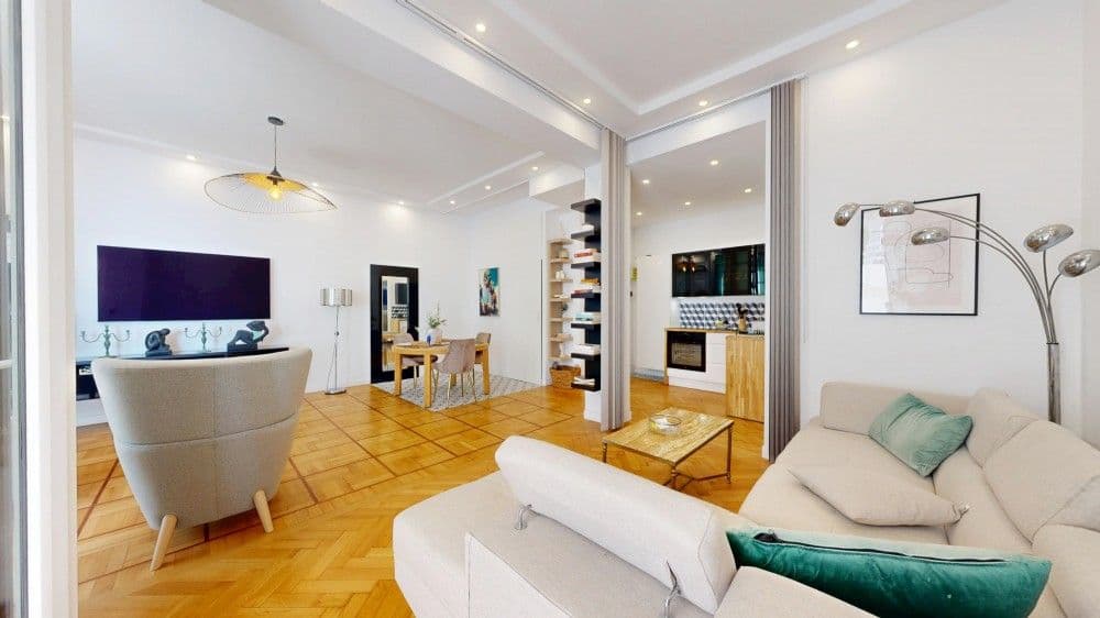 Living room with sofa, armchairs and dining area, 1-bedroom apartment in the Promenade des Anglais, Nice