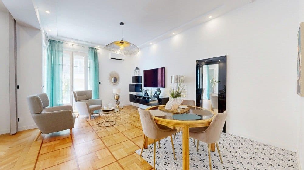 Living room with dining table and cement tiles, 1-bedroom apartment in the Promenade des Anglais, Nice