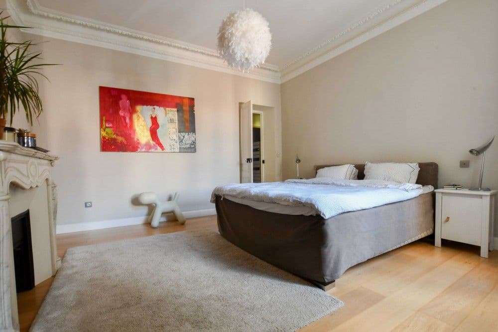 Main bedroom with marble fireplace, moulded ceiling and oak floor, 3-bedroom apartment in the Carré d’Or, Nice