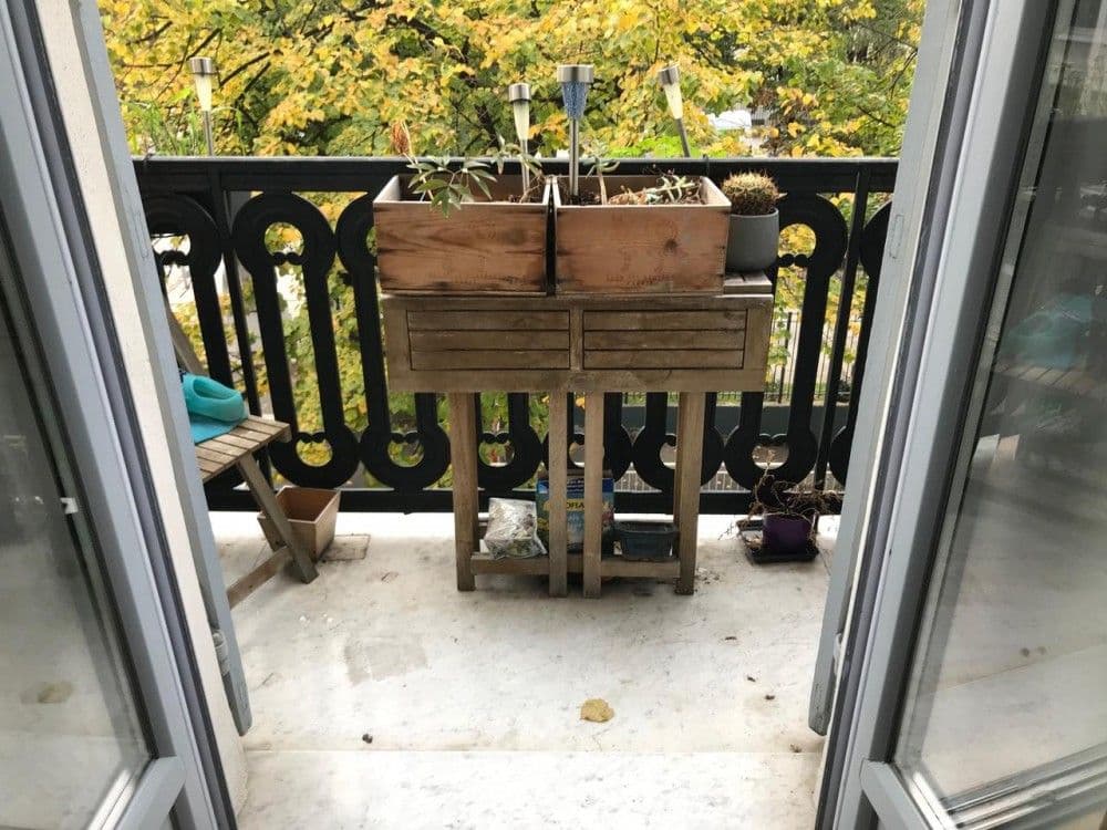 Balcony with wrought-iron railing and planters overlooking trees, 2-bedroom apartment in central Nice