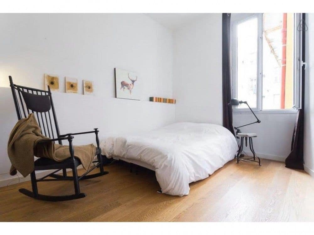 Bedroom with rocking chair, double bed and tall window, 2-bedroom apartment in central Nice
