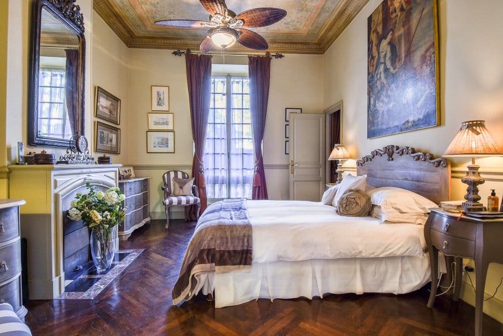 Bedroom with fireplace, carved bed and ceiling fan, 2-bedroom apartment in central Nice