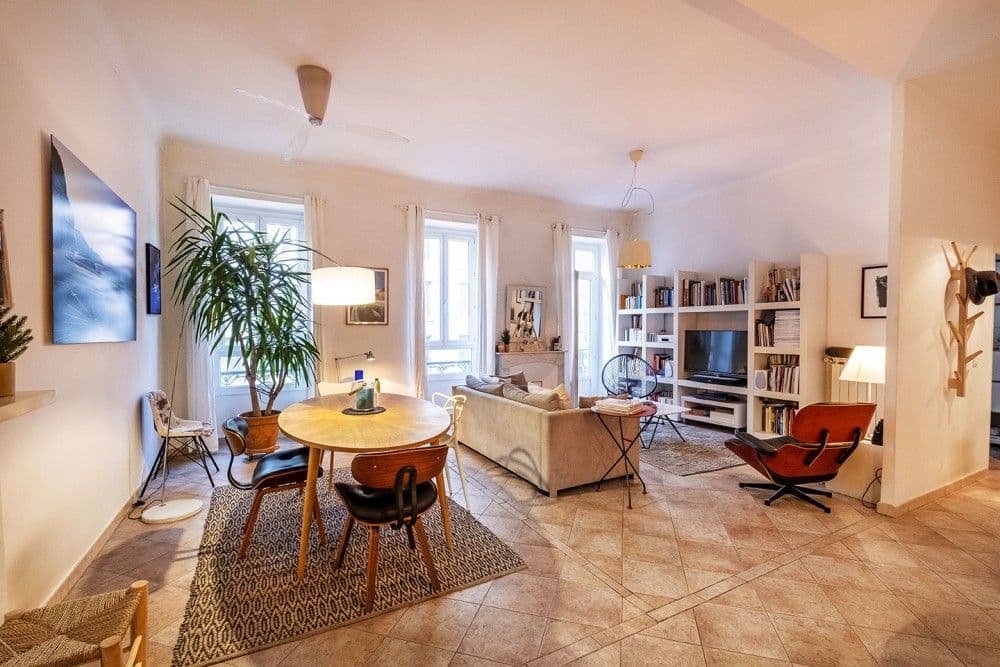 Living and dining room with terracotta tiled floor and tall windows, 3-bedroom apartment in the Port, Nice