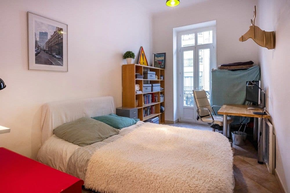 Bedroom with double bed, bookshelf and French window, 3-bedroom apartment in the Port, Nice