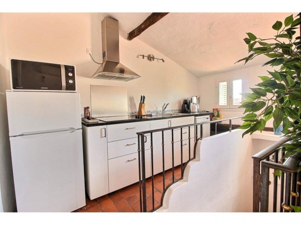 Kitchen on the upper level with stainless steel hood, 2-bedroom apartment in the Old Town, Nice