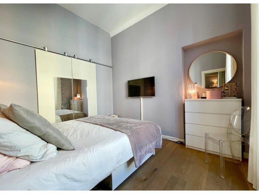 Bedroom with sliding barn door, chest of drawers and oak floor, 2-bedroom apartment in Nice
