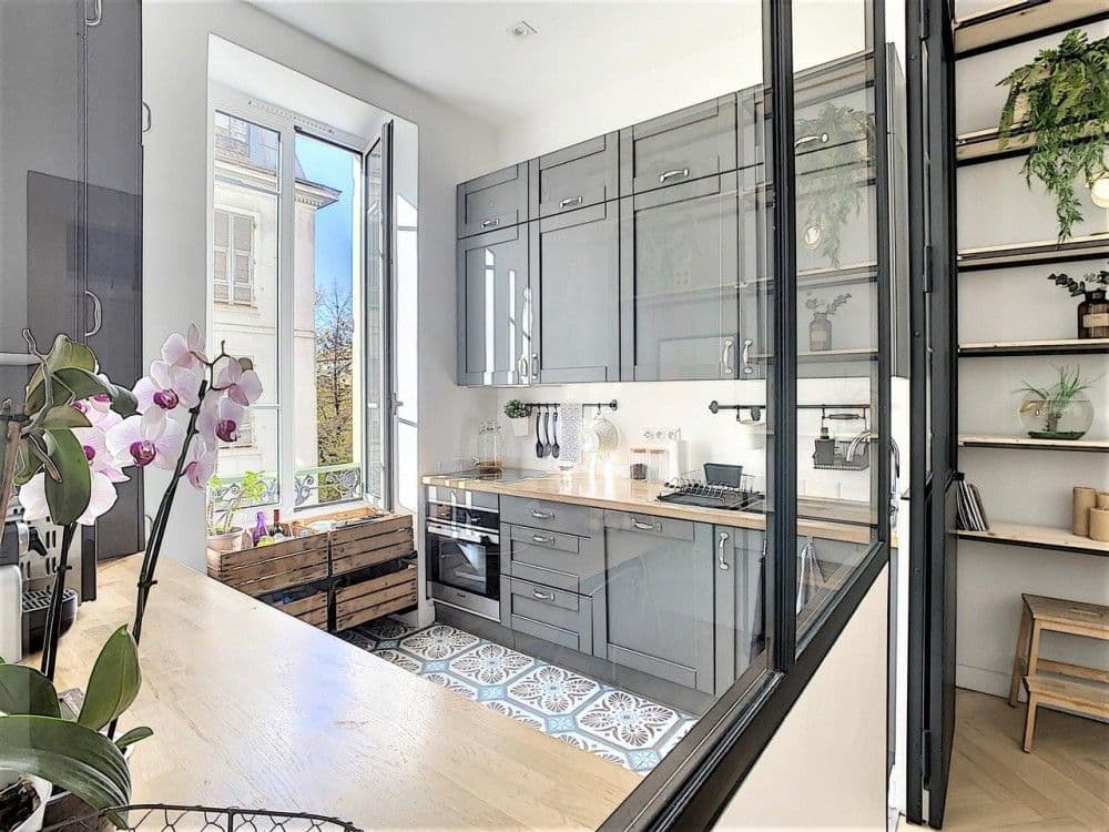 Kitchen behind a glass partition with cement tiles and tall window, 3-bedroom apartment in Nice