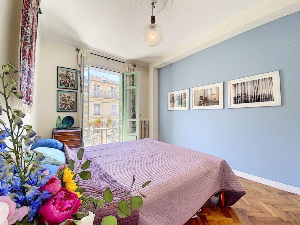Bedroom with blue feature wall and French window to the balcony, 2-bedroom apartment in the Port, Nice