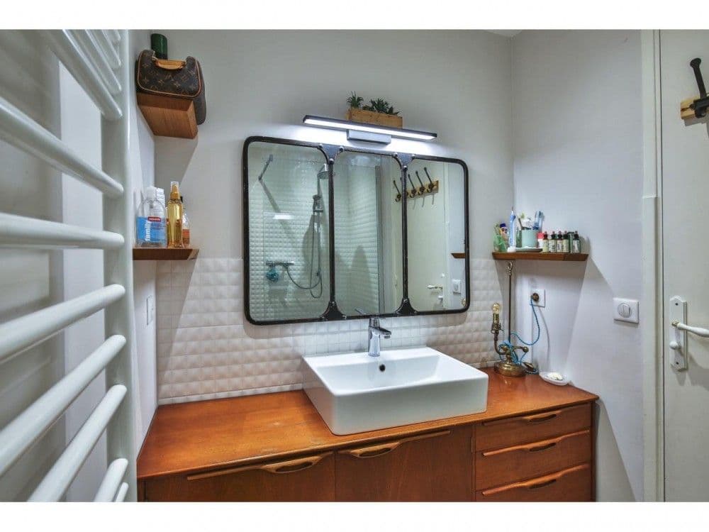 Bathroom with wooden vanity and black-framed mirror, 2-bedroom apartment in the Port, Nice